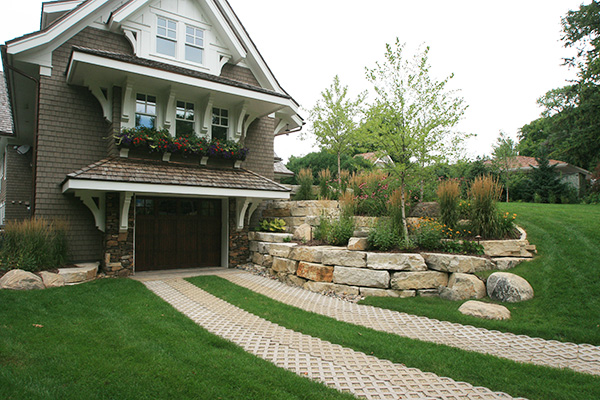 Limestone Retaining wall with Boulder outcroppings, Pavers Concrete grass Pavers, Plantings single Stem Birch, Native Grasses, Perennials. Shorewood, mn
