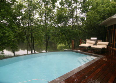 Custom Concrete Vanishing Edge Swimming Pool with Wood Deck Surround