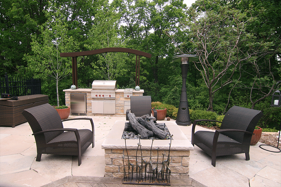Custom Outdoor kitchen with metal arbor and gas fire feature