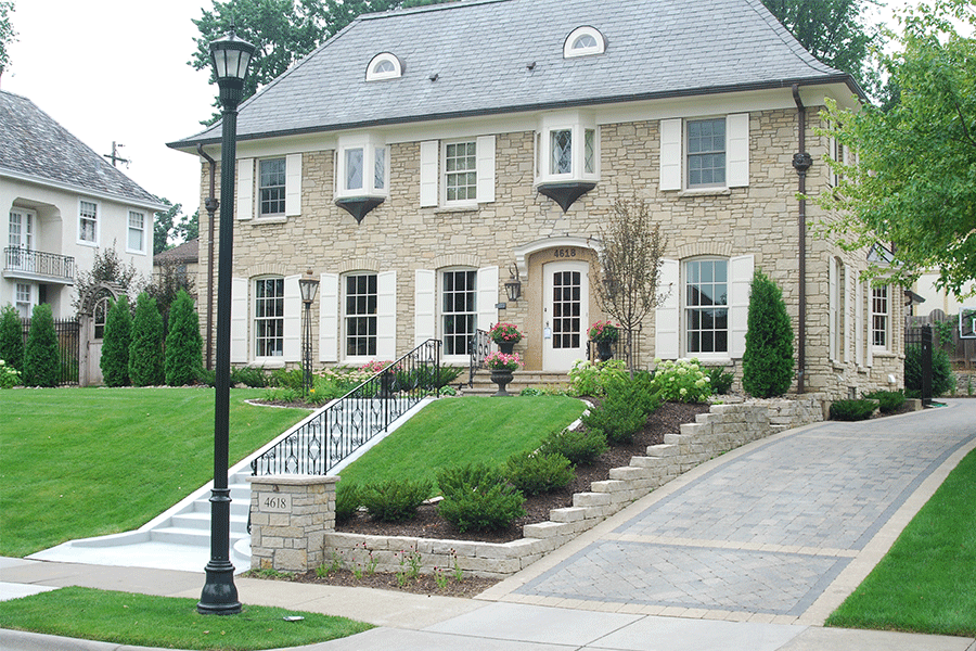 Front Entry After Photo with New Paver Driveway Limestone Walls and New Staircase with Plantings