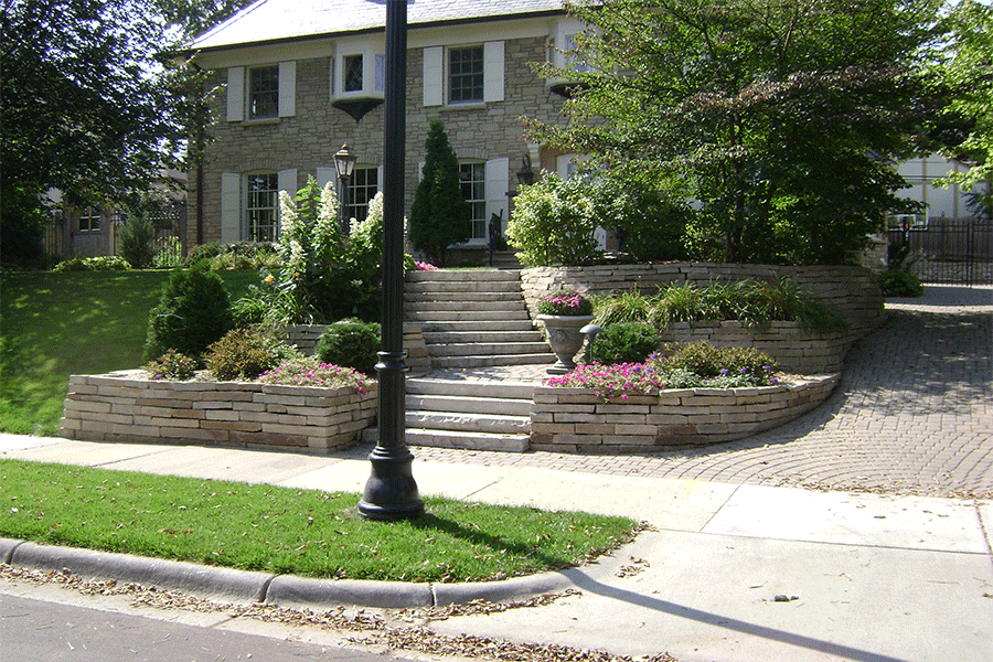 Front Entry Remodel with Updated Paver Driveway, Limestone Walls, and Staircase