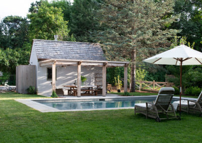 European Style Cottage with Concrete Pool Set in Grass in Deephaven, MN