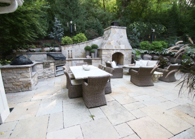 Limestone Outdoor Kitchen with Fireplace, Multiple Grills, and Stone Countertop