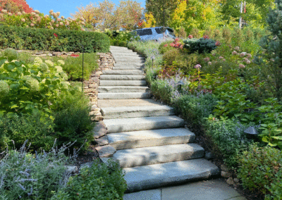 Lush Walkway to Upper Carport with Bluestone Steppers and Dry Stacked Walls