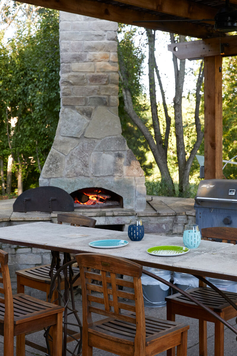 Mortarted-Stone-Pizza-Oven-in-Outdoor-Kitchen-with-Stone-Top-and-Metal-Legs-in-Minnesota