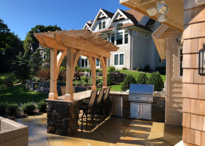 Granite and Limestone Outdoor Kitchen with Cedar Pergola
