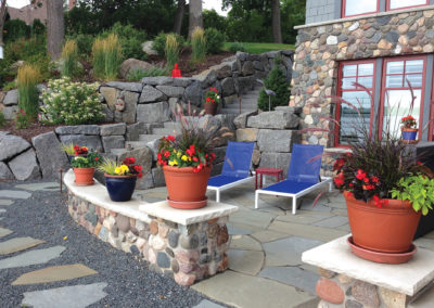 Irregular Granite Boulder Wall and Stairs, Bluestone Patio, and a River Rock Seated Wall in White Bear Lake, MN