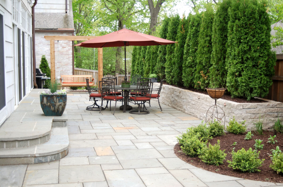 Limestone Raised Bed with Arborvitae for Screening in Minneapolis MN