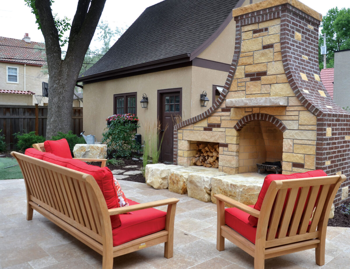 Stone Fireplace separates the driveway from entertaining area in Edina, Minnesota