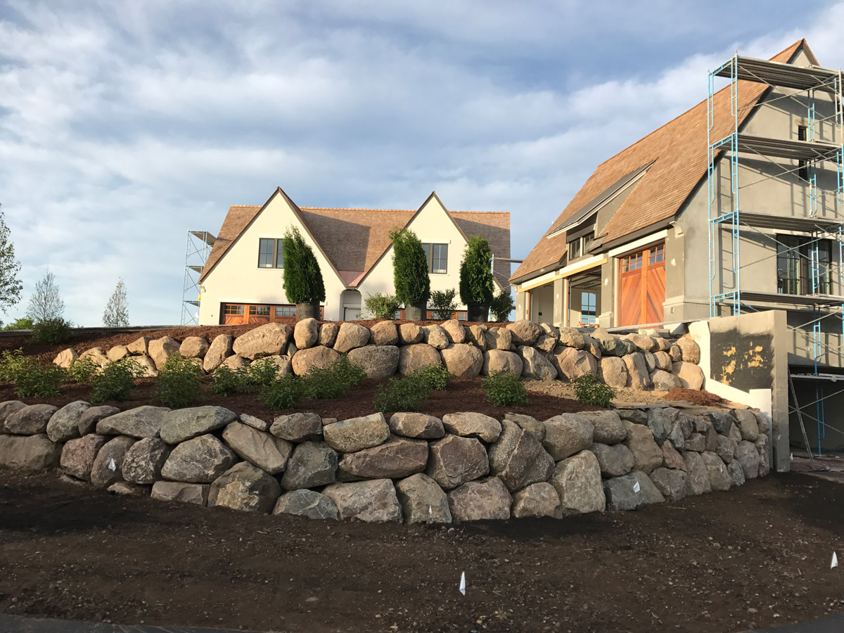 Large Boulder Walls with Boxwood Plantings